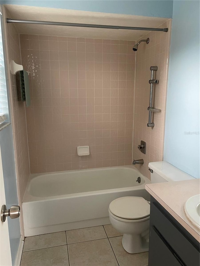 full bathroom with toilet, vanity, tile patterned floors, and tiled shower / bath combo