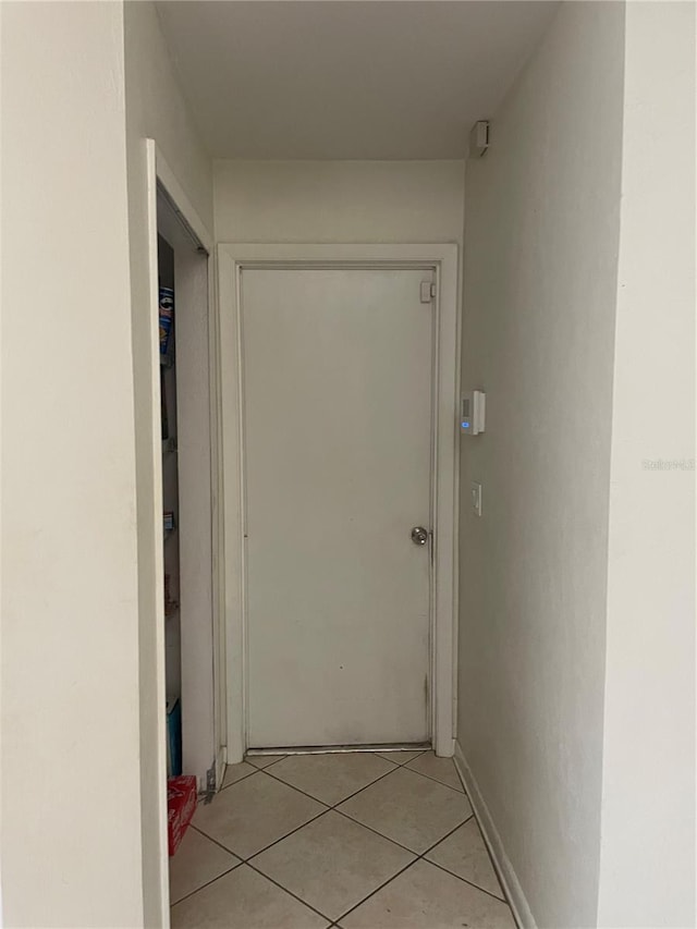 hallway with light tile patterned floors