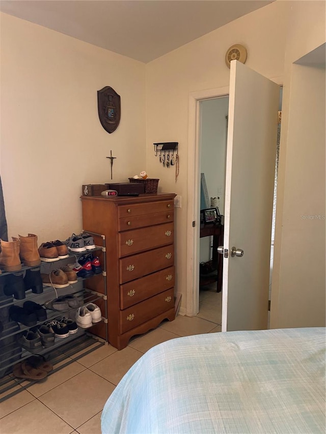 bedroom with light tile patterned floors