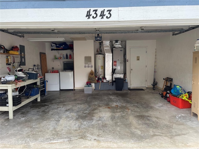 garage with heating unit, stainless steel fridge, gas water heater, and independent washer and dryer