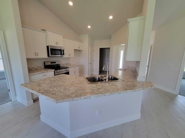 kitchen featuring white cabinetry, sink, high vaulted ceiling, kitchen peninsula, and appliances with stainless steel finishes