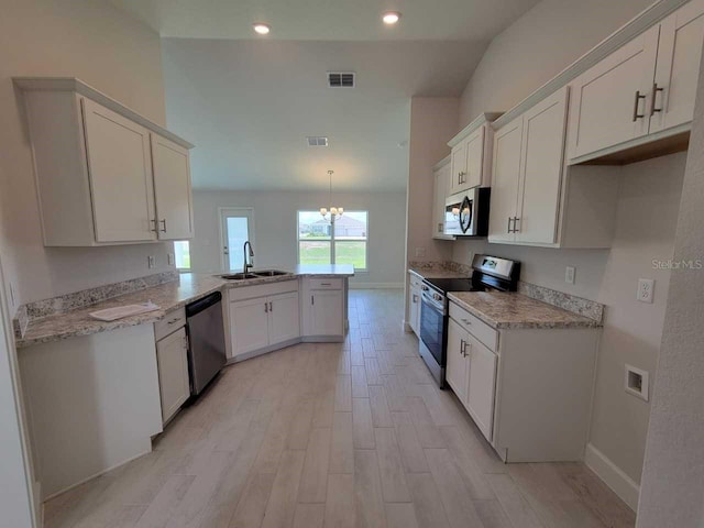 kitchen with kitchen peninsula, stainless steel appliances, sink, white cabinets, and light hardwood / wood-style floors