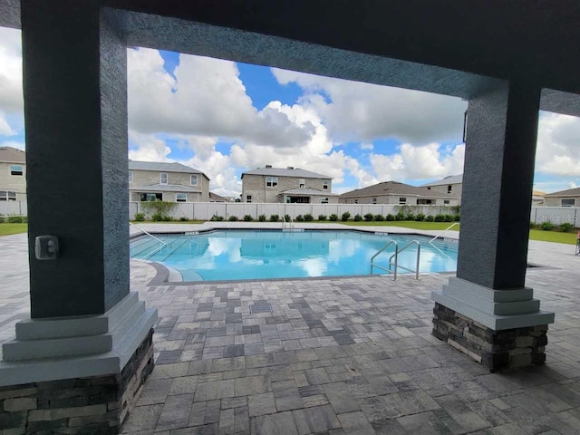 view of swimming pool with a patio area, fence, and a fenced in pool