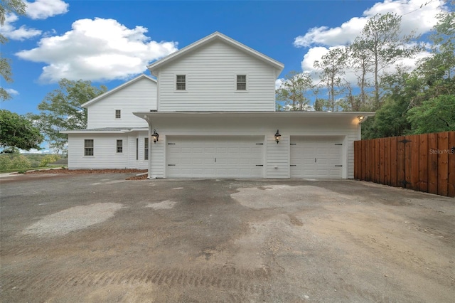 exterior space with driveway and fence