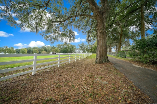 view of yard featuring a rural view and fence