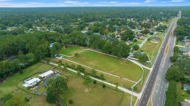 birds eye view of property featuring a forest view