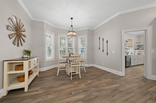 dining area featuring a notable chandelier, wood finished floors, and crown molding