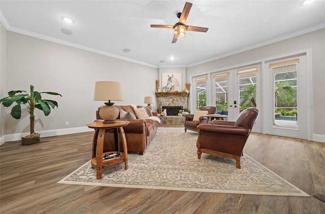 living room with french doors, baseboards, wood finished floors, and ornamental molding