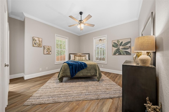 bedroom featuring baseboards, dark wood finished floors, and ornamental molding