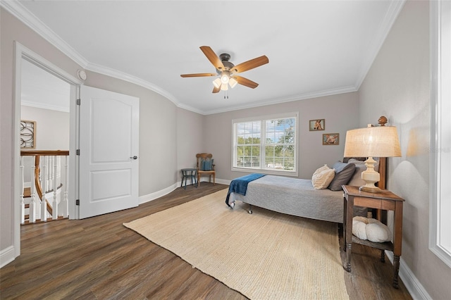 bedroom featuring ceiling fan, baseboards, wood finished floors, and ornamental molding