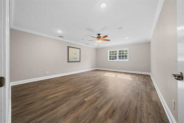 empty room with visible vents, dark wood finished floors, crown molding, baseboards, and ceiling fan