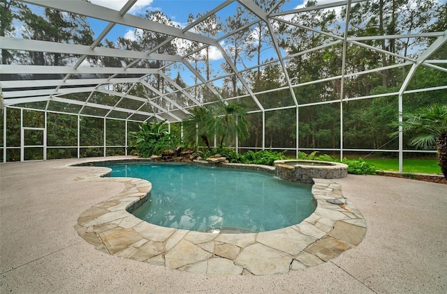 view of swimming pool featuring glass enclosure, a patio area, and a pool with connected hot tub