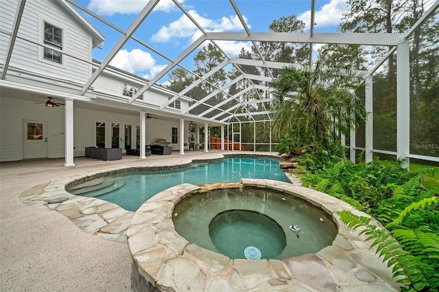 view of pool featuring a patio, a ceiling fan, a pool with connected hot tub, french doors, and a lanai