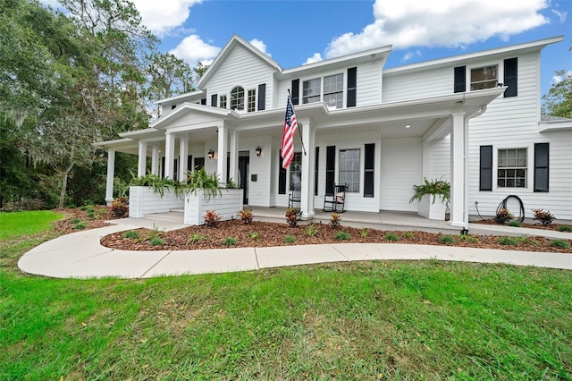 view of front of house with a porch and a front lawn