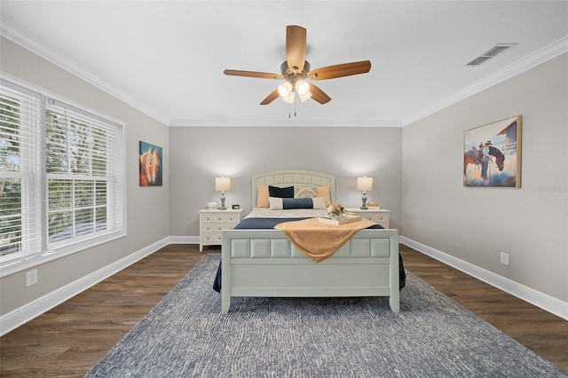 bedroom featuring wood finished floors, visible vents, and ornamental molding