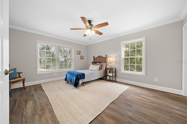 bedroom featuring ceiling fan, crown molding, baseboards, and wood finished floors