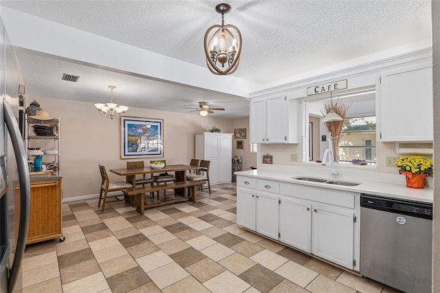 kitchen with pendant lighting, white cabinets, and stainless steel dishwasher