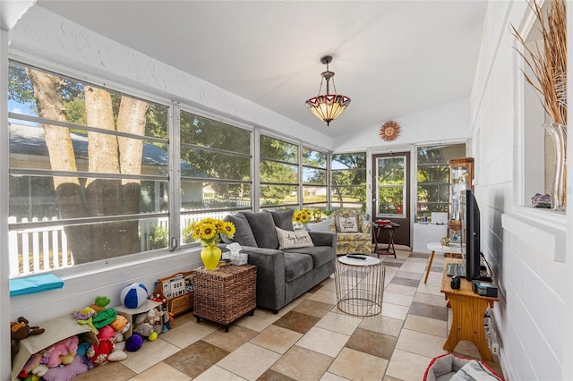 sunroom featuring vaulted ceiling