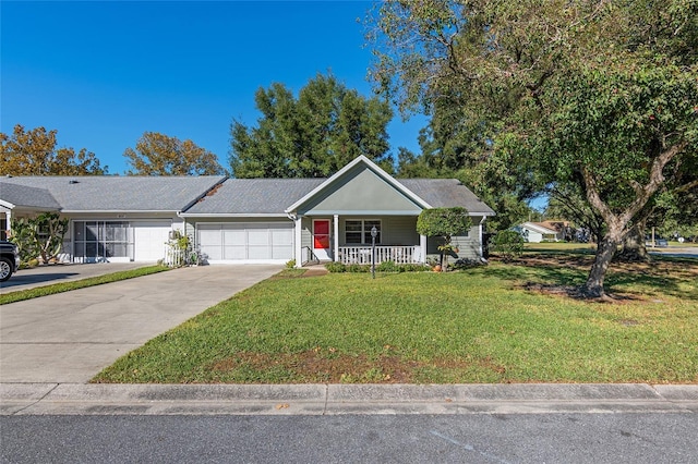 single story home featuring covered porch, a garage, and a front yard