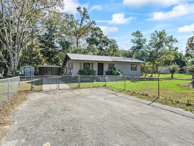 ranch-style house with a front yard and a storage unit