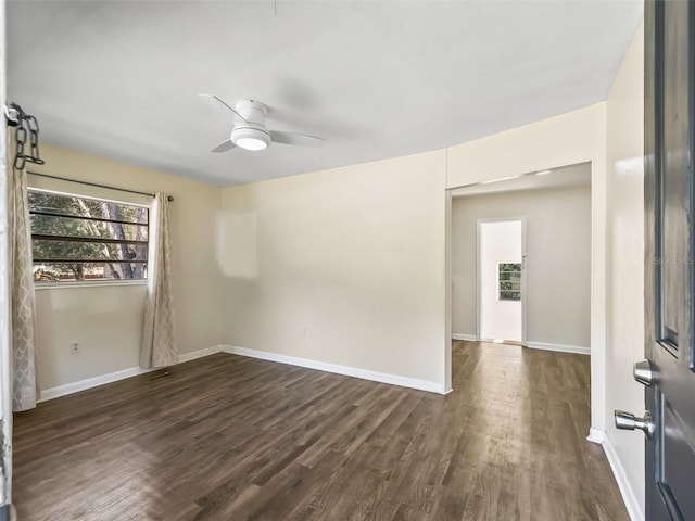 spare room with dark hardwood / wood-style flooring and ceiling fan