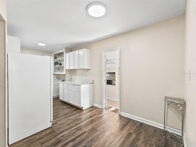 kitchen featuring white refrigerator, white cabinetry, and dark wood-type flooring