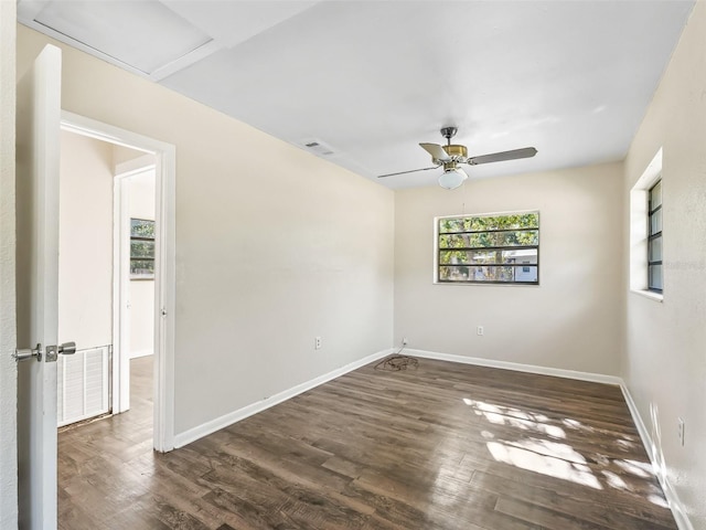 spare room featuring ceiling fan and dark wood-type flooring