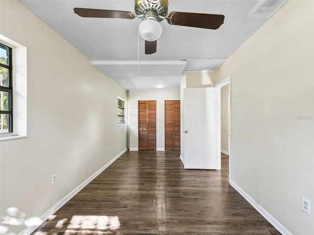 empty room featuring ceiling fan and dark hardwood / wood-style floors