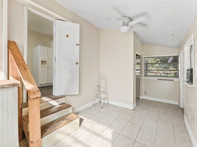 interior space with ceiling fan, tile patterned flooring, and lofted ceiling