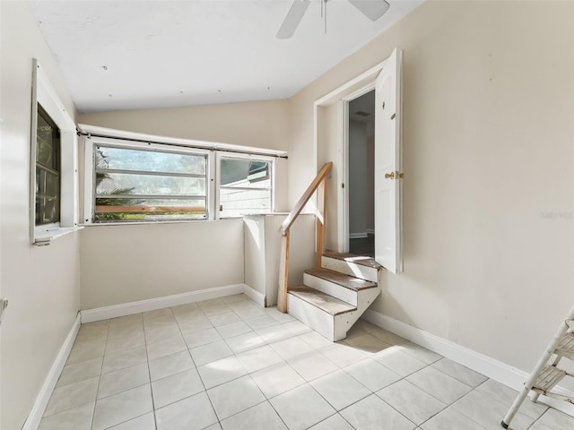 stairs with tile patterned floors, ceiling fan, and lofted ceiling