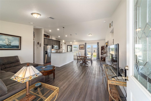 living room featuring dark hardwood / wood-style flooring and lofted ceiling