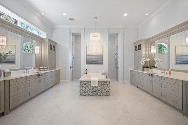 bathroom featuring vanity, crown molding, plenty of natural light, and a bathtub