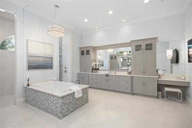 bathroom featuring vanity, ornamental molding, and tiled tub