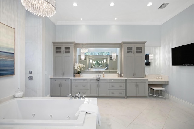 bathroom featuring crown molding, a washtub, vanity, and a chandelier