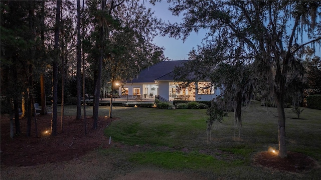 exterior space featuring a yard and a wooden deck