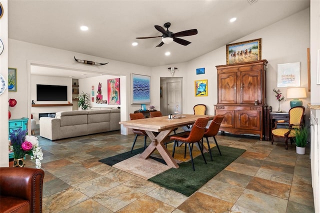 dining space featuring ceiling fan and lofted ceiling