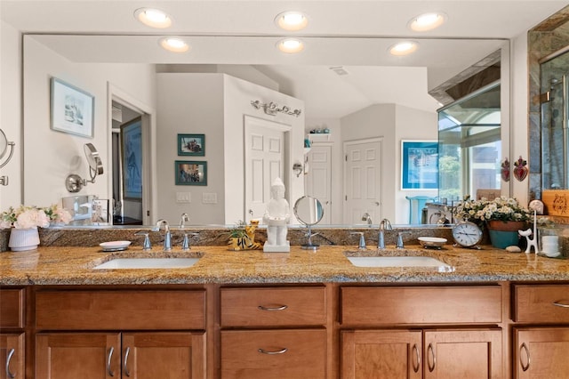 bathroom with vanity, a shower with door, and vaulted ceiling