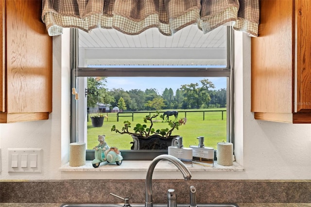 kitchen featuring beam ceiling, a wealth of natural light, and sink