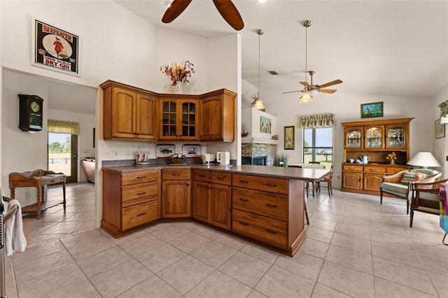 kitchen with a wealth of natural light, high vaulted ceiling, light tile patterned flooring, and ceiling fan