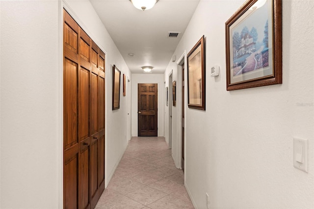 hallway featuring light tile patterned floors