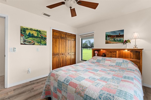 bedroom with hardwood / wood-style floors, ceiling fan, and a closet