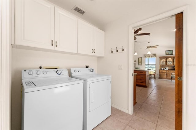 washroom with separate washer and dryer, ceiling fan, light tile patterned floors, and cabinets