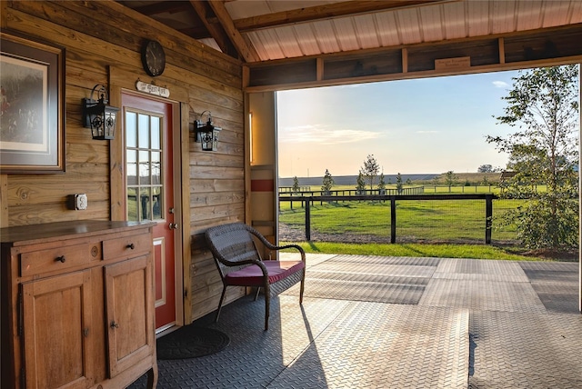 sunroom / solarium with vaulted ceiling with beams and a rural view