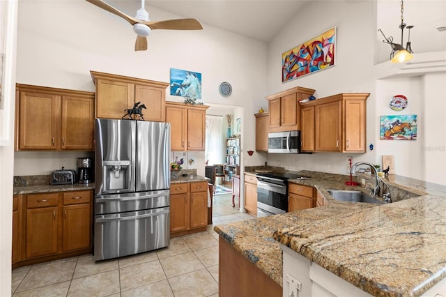 kitchen with sink, light tile patterned floors, stainless steel appliances, and high vaulted ceiling