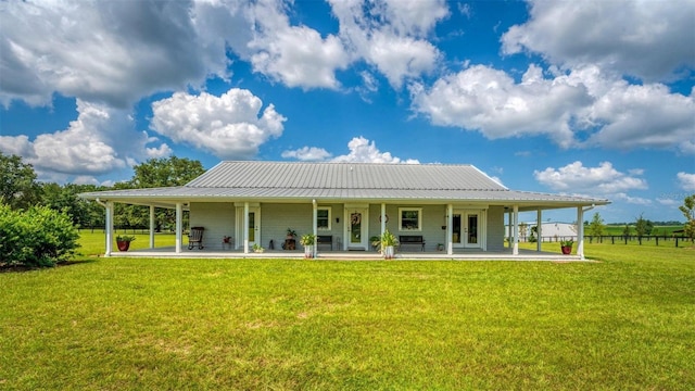 rear view of property featuring a yard