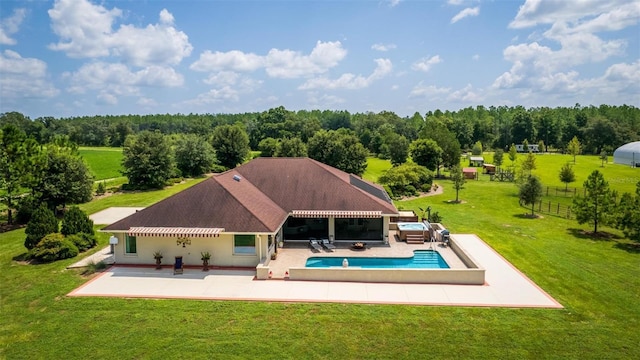 back of house featuring a patio area, an outdoor living space, and a yard