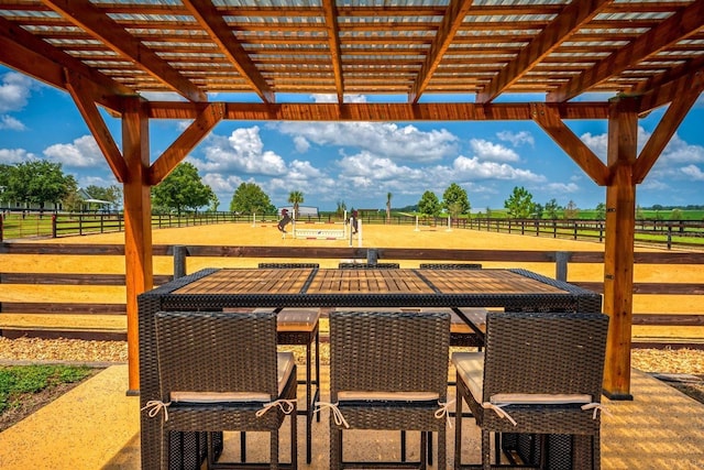 view of patio / terrace featuring a rural view and a pergola