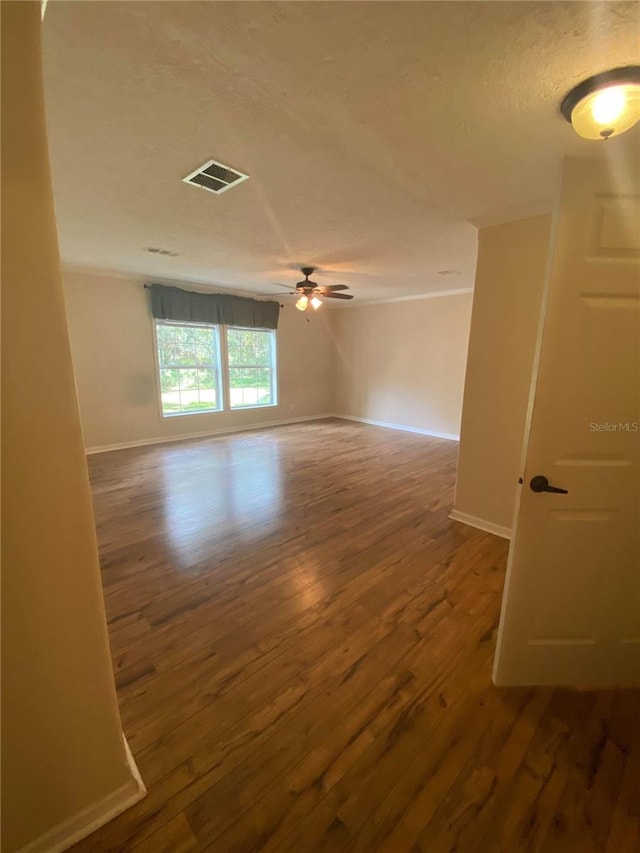 unfurnished room featuring ceiling fan and hardwood / wood-style flooring