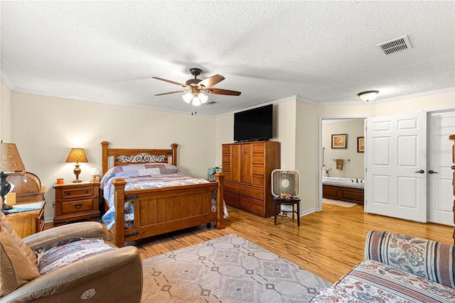 bedroom with connected bathroom, ceiling fan, light hardwood / wood-style flooring, and a textured ceiling