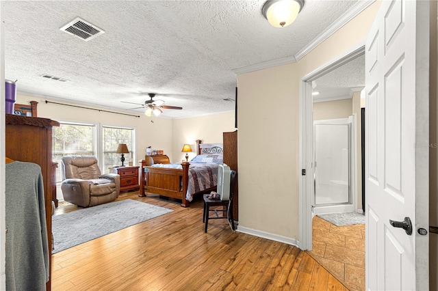 bedroom featuring wood-type flooring, a textured ceiling, ceiling fan, and ornamental molding